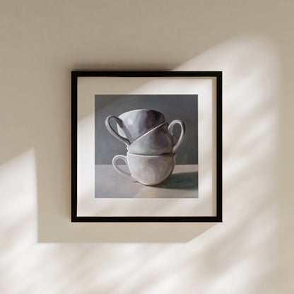 This artwork features a stack of three porcelain coffee cups.