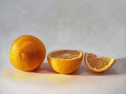 This artwork features a whole orange, half orange, and quarter slice of an orange resting on a light surface.