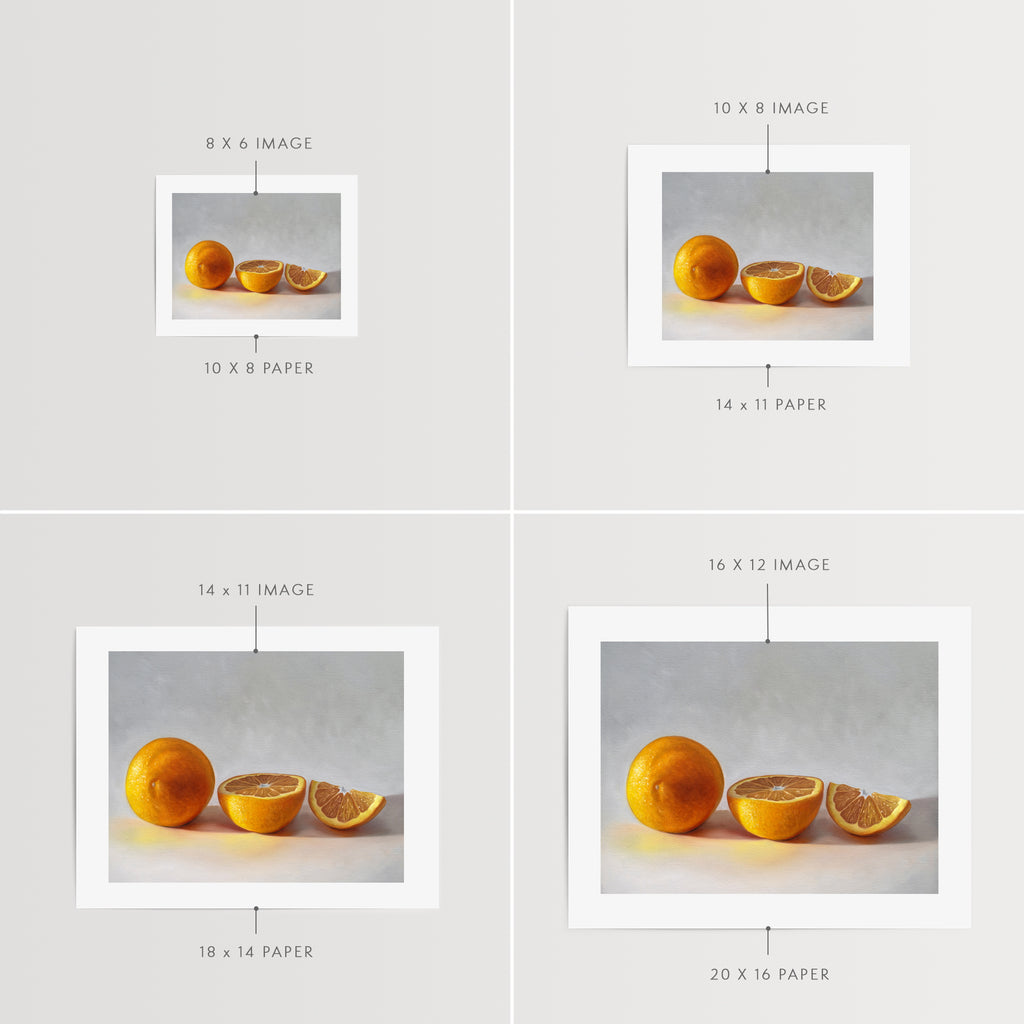 This artwork features a whole orange, half orange, and quarter slice of an orange resting on a light surface.