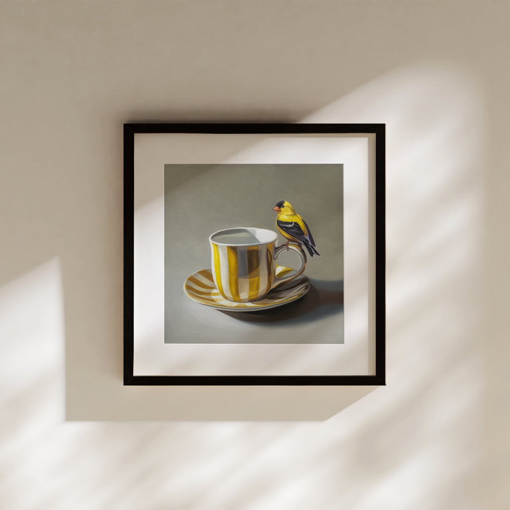 This artwork features an American Goldfinch perched on the handle of a whimsical yellow and white striped cup with saucer.