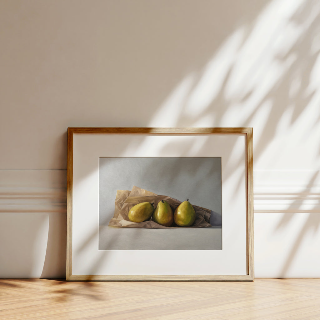 This artwork features a trio of pears nested in a brown piece of parchment paper.