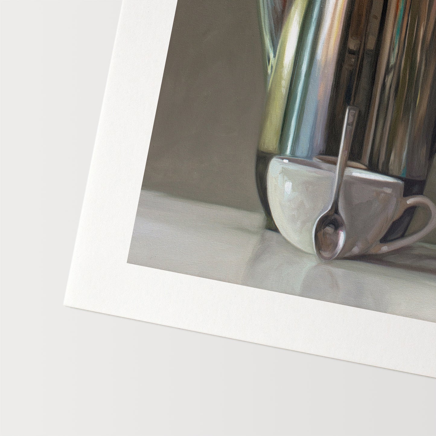 This artwork features a reflective percolator, porcelain coffee cup and small spoon resting on a light reflective surface with neutral grey tones.