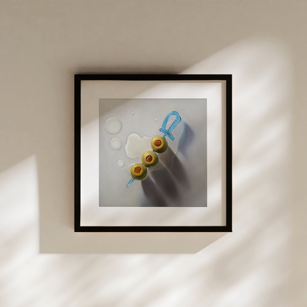 This artwork features a trio of green olives on a blue cocktail sword with some nice dramatic lighting.