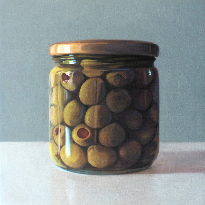 This artwork features a jar of green olives resting on a light, reflective surface with a muted blue/green background.