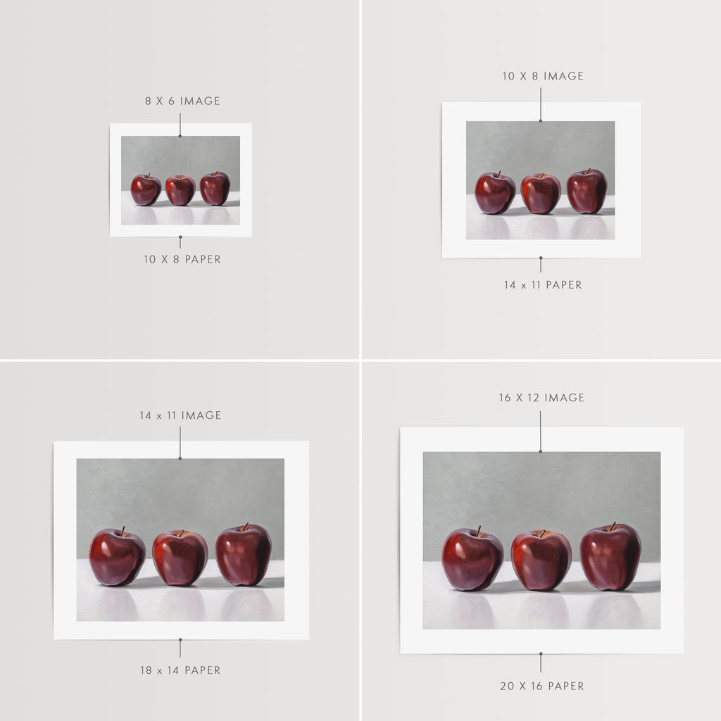This artwork features a trio of Red Delicious apples resting on a light surface with a neutral grey background.