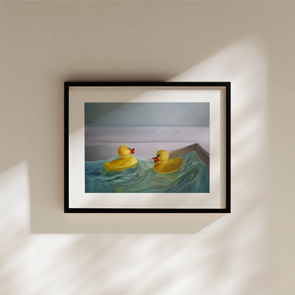 This artwork a pair of rubber duckies hitting the waves in a bathroom sink with some nice dramatic lighting.