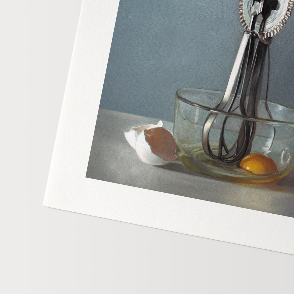 This artwork features an antique egg beater and a glass bowl containing an egg white the white shells juxtaposed on the left.