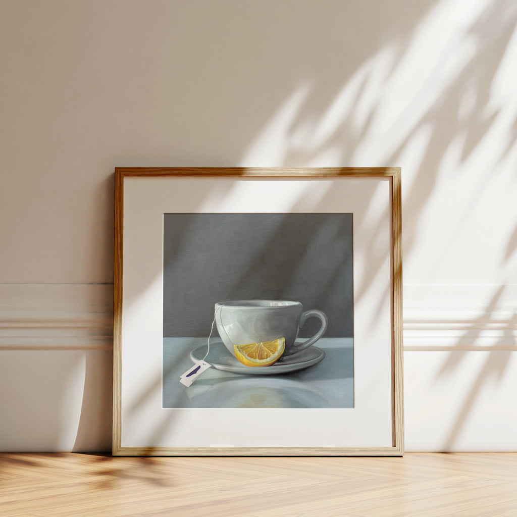 This artwork features a porcelain cup and saucer with tea and a lemon wedge.