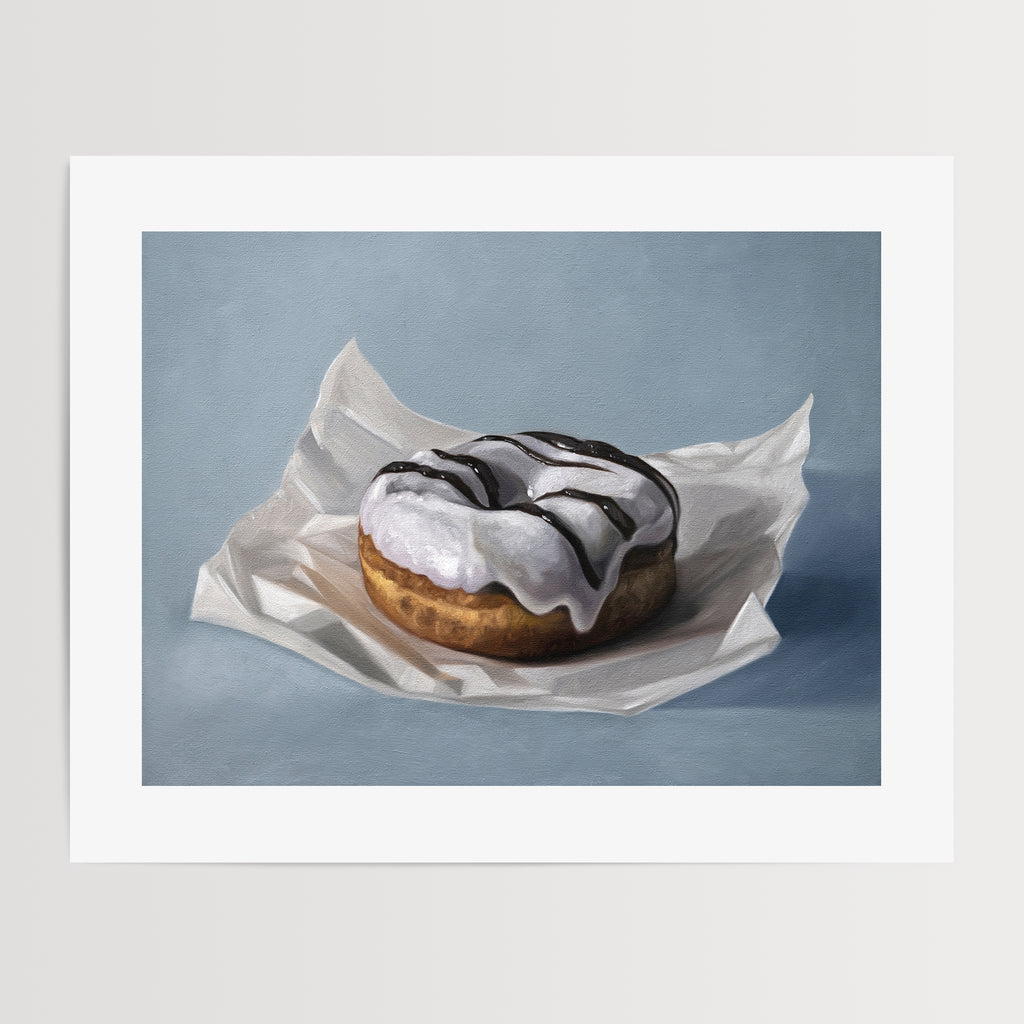 This artwork features a single iced donut resting on a piece of crumpled wax paper resting on a light blue surface.
