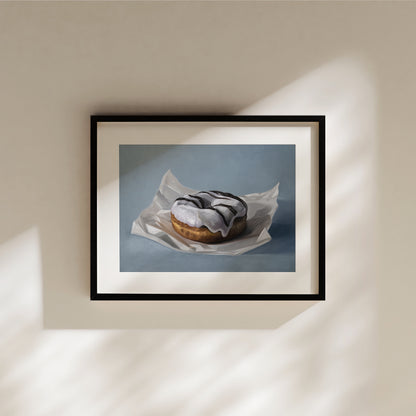 This artwork features a single iced donut resting on a piece of crumpled wax paper resting on a light blue surface.