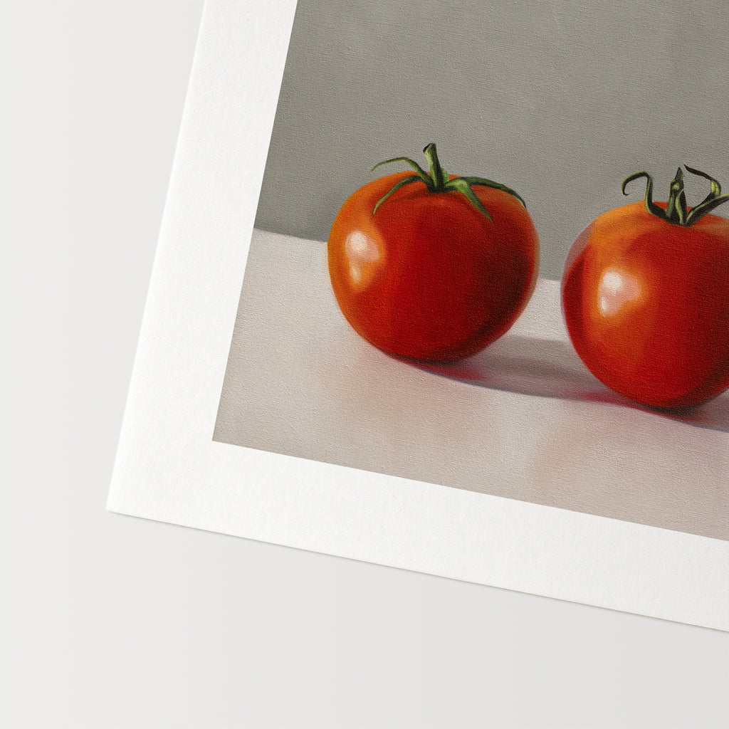 This artwork features a trio of bright red tomatoes resting on a light, reflective surface and a neutral backdrop.
