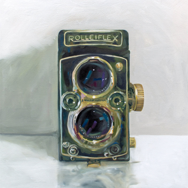 This artwork features a vintage film camera on a light reflective surface and grey background.