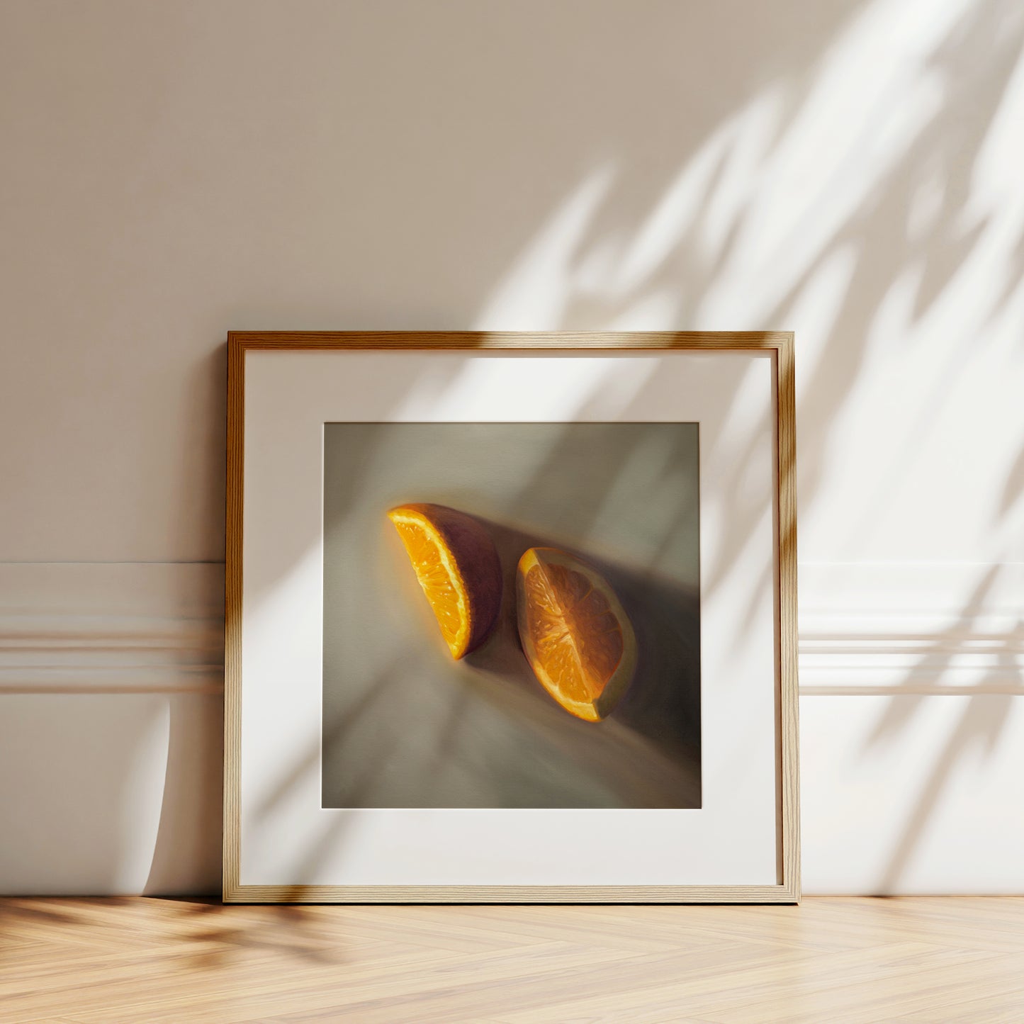 This artwork features a pair of orange wedges resting on a light grey surface with dramatic lighting.