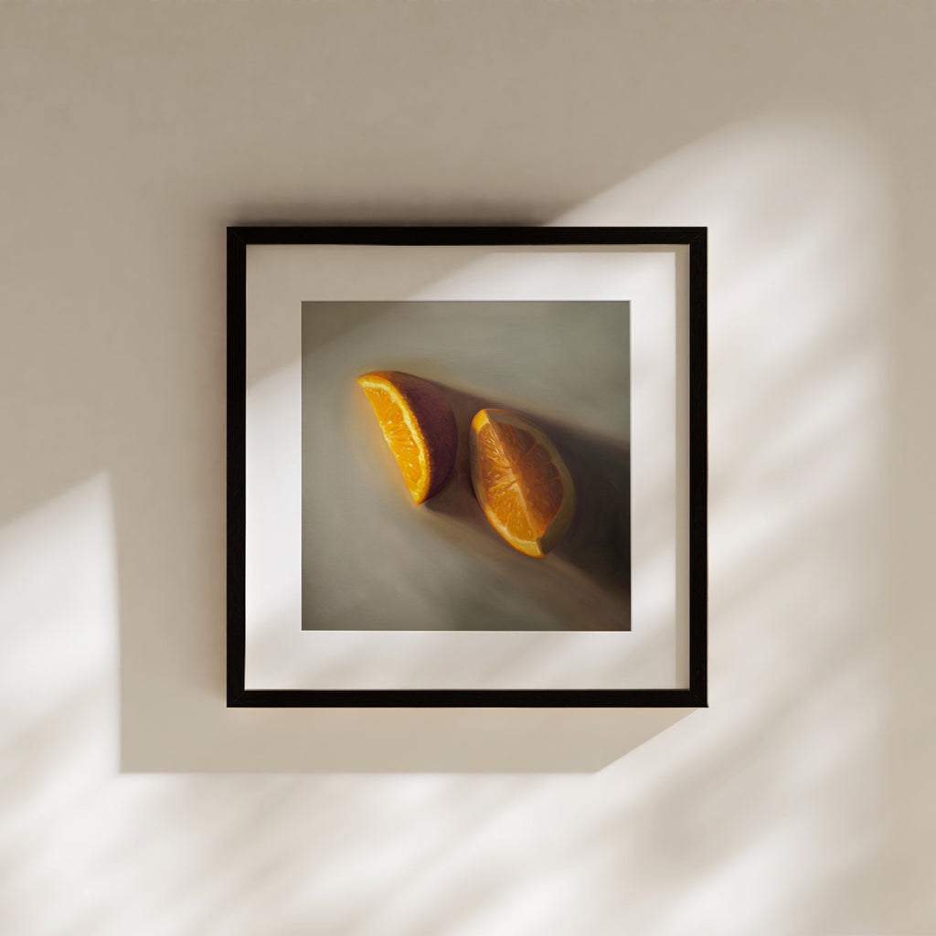 This artwork features a pair of orange wedges resting on a light grey surface with dramatic lighting.