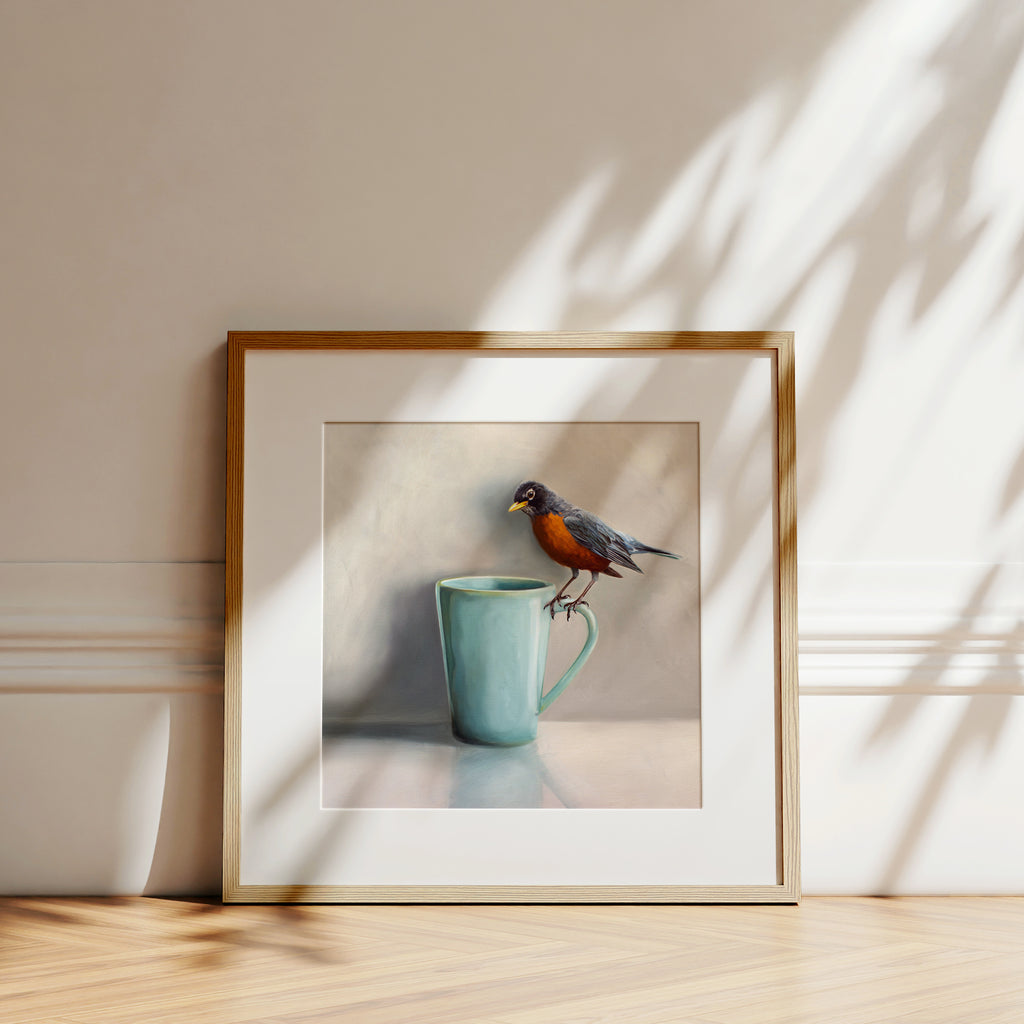 This artwork features a an American Robin perching on the handle of a coffee cup that is a beautiful shade of Robin’s Egg Blue.