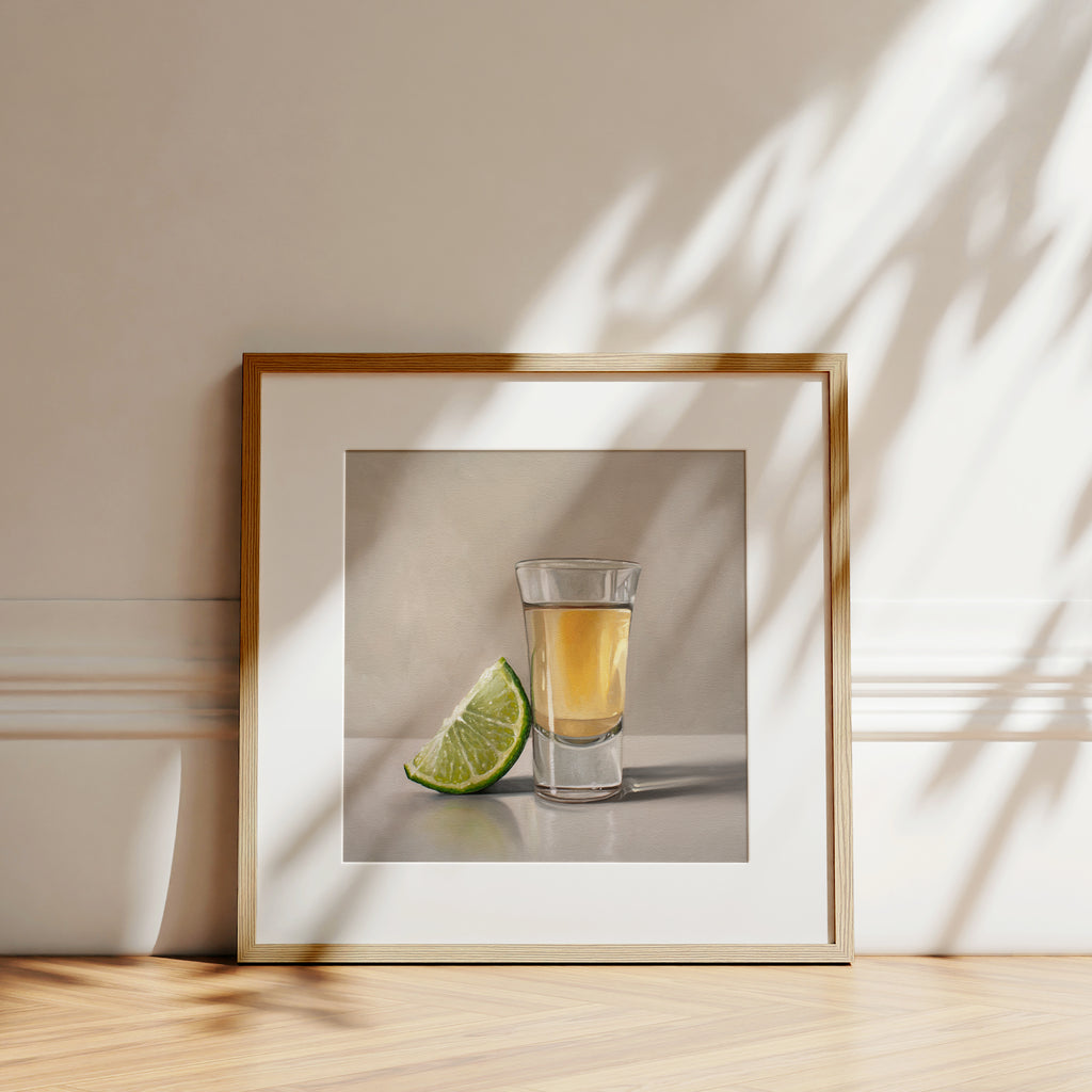 This artwork features a freshly sliced lime leaning on a golden shot of tequila.