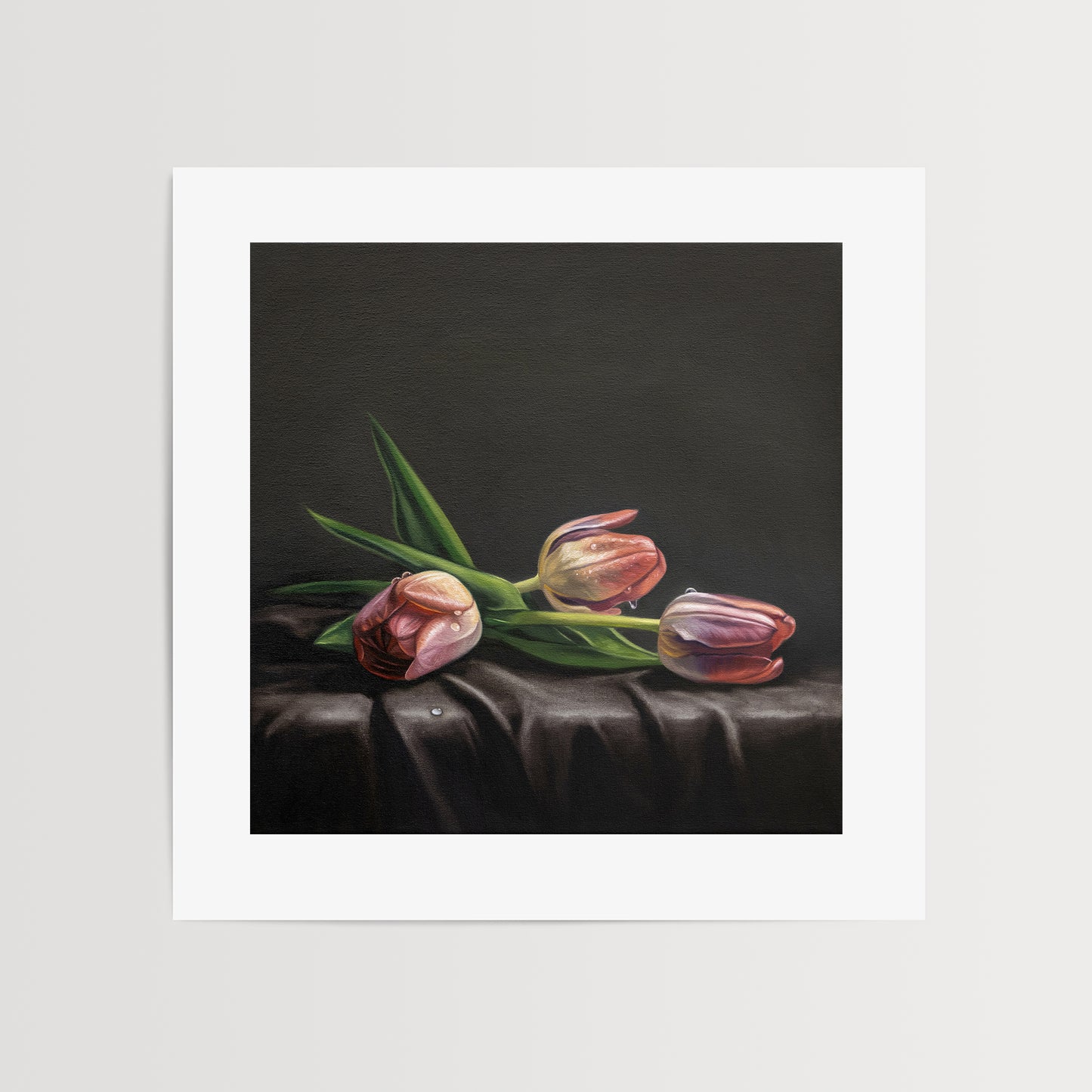 This artwork features a trio of dew drop tulips resting on draped dark satin fabric.