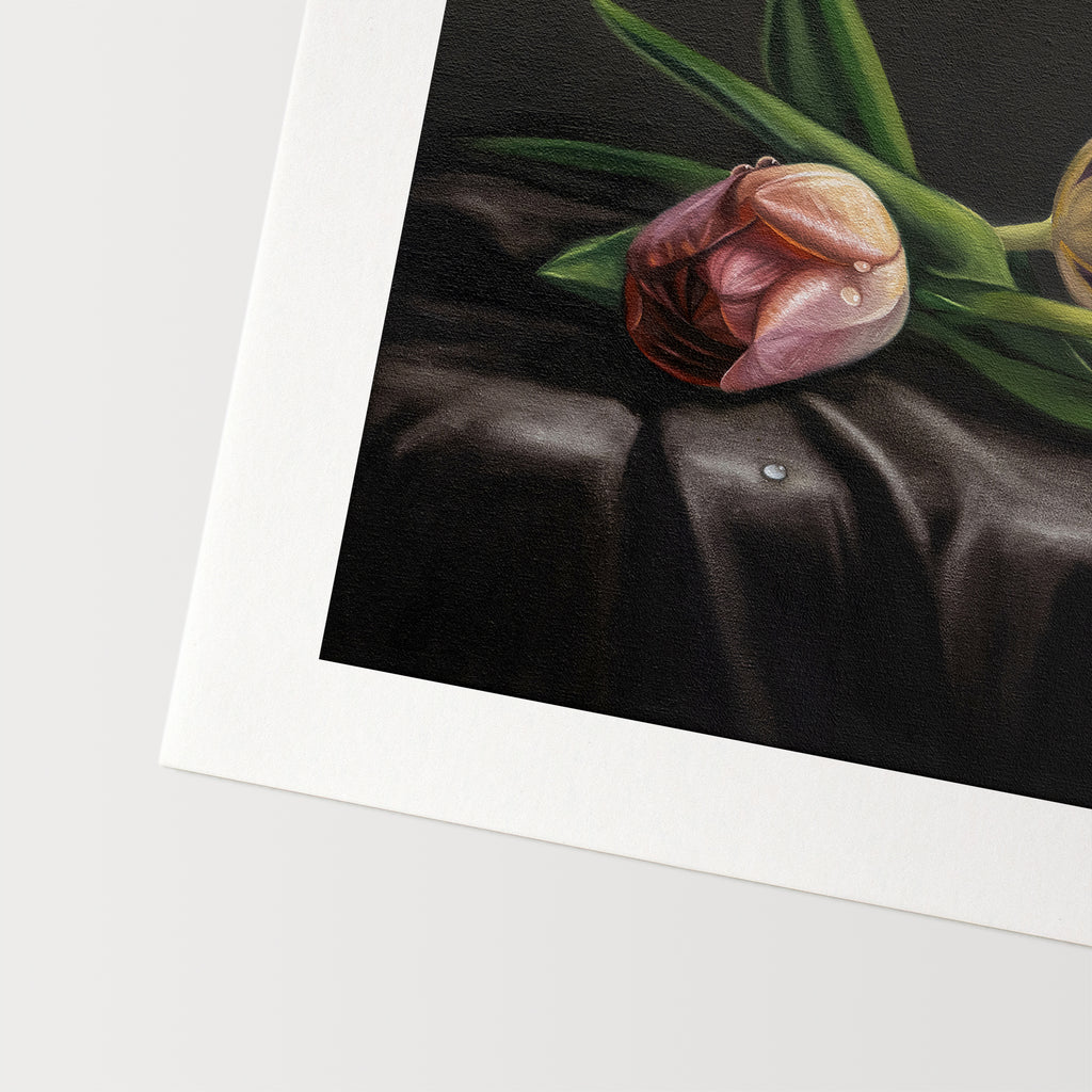 This artwork features a trio of dew drop tulips resting on draped dark satin fabric.