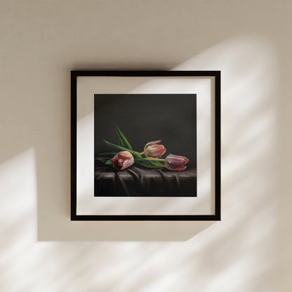 This artwork features a trio of dew drop tulips resting on draped dark satin fabric.