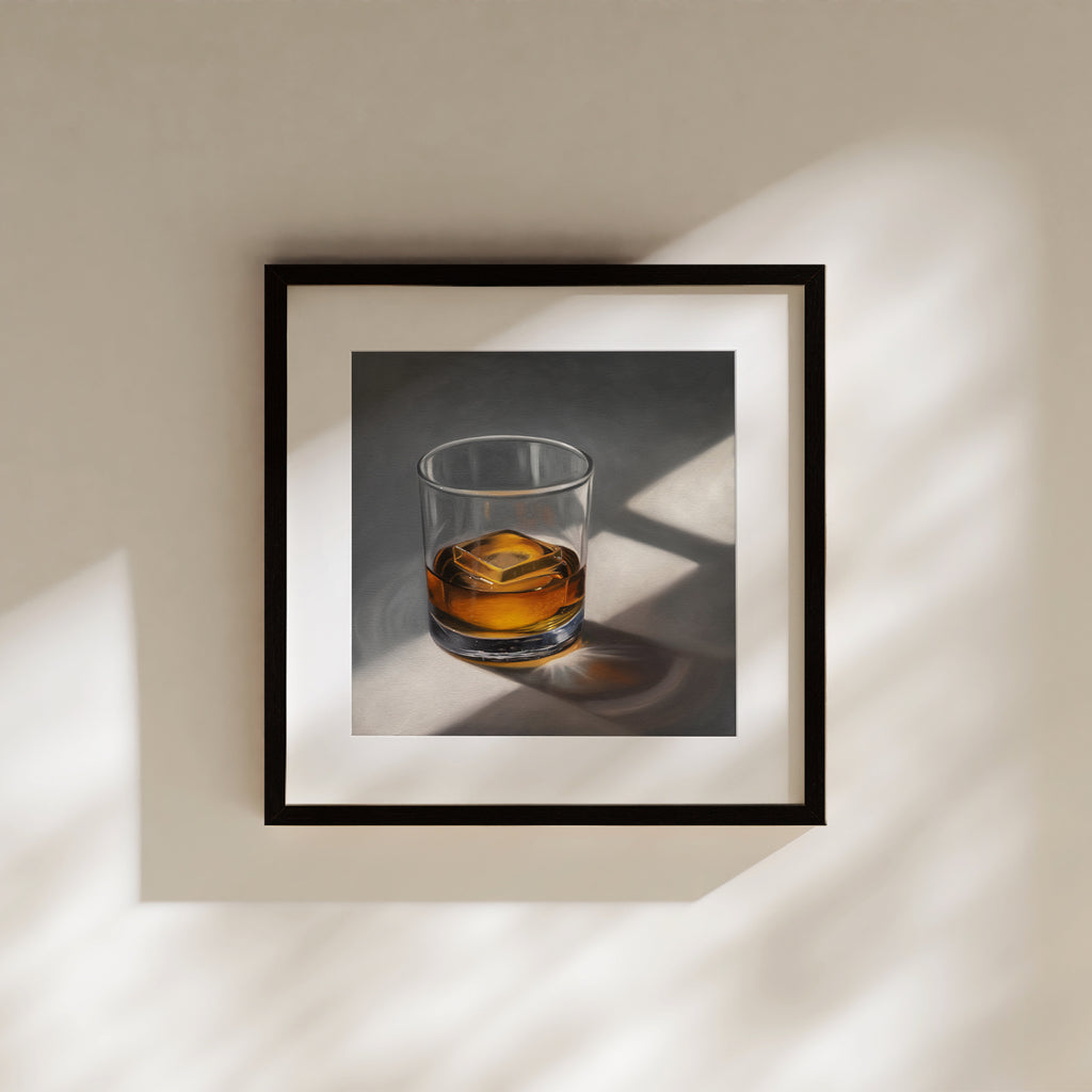 This artwork features a glass of whiskey with a single clear ice cube resting on a neutral surface with dramatic lighting from a window.