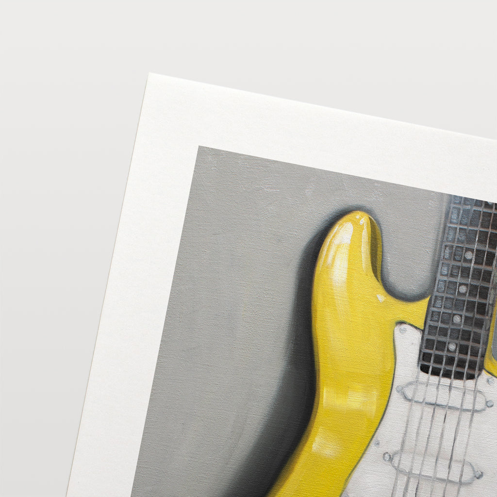 This artwork features a close up view of a bright yellow Stratocaster Guitar resting on a light grey surface.