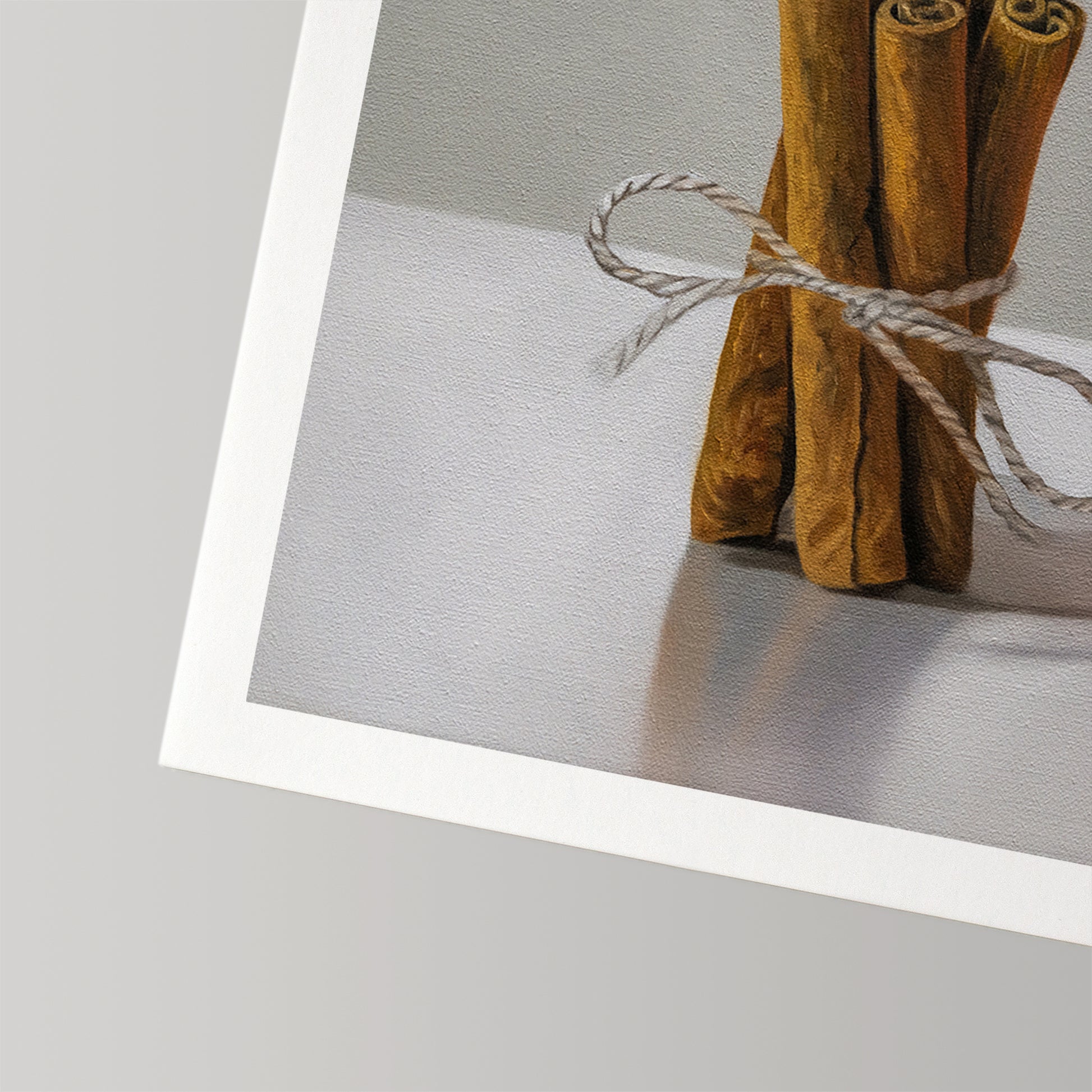 Fine art print of cinnamon sticks tied with twine on white cotton rag paper.