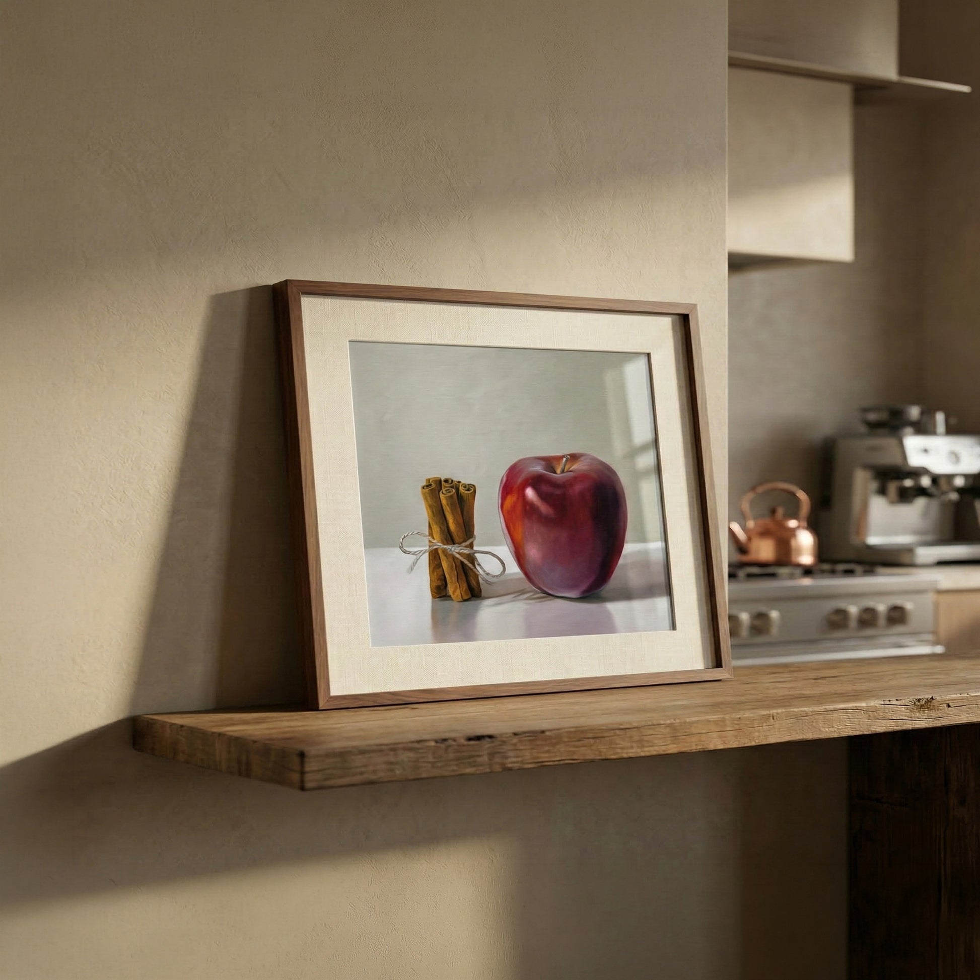 Framed "Apple Cinnamon" fine art print on a rustic wooden shelf in a modern kitchen.