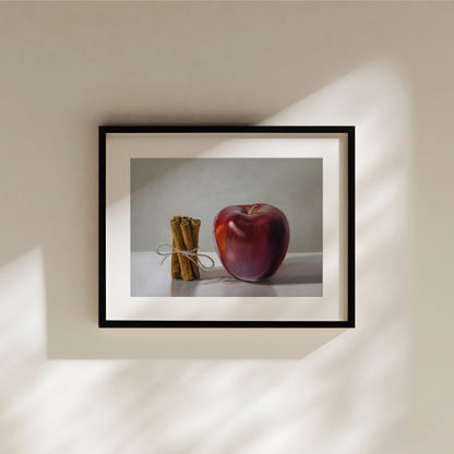 Framed "Apple Cinnamon" fine art print featuring a vibrant red apple and tied cinnamon sticks.
