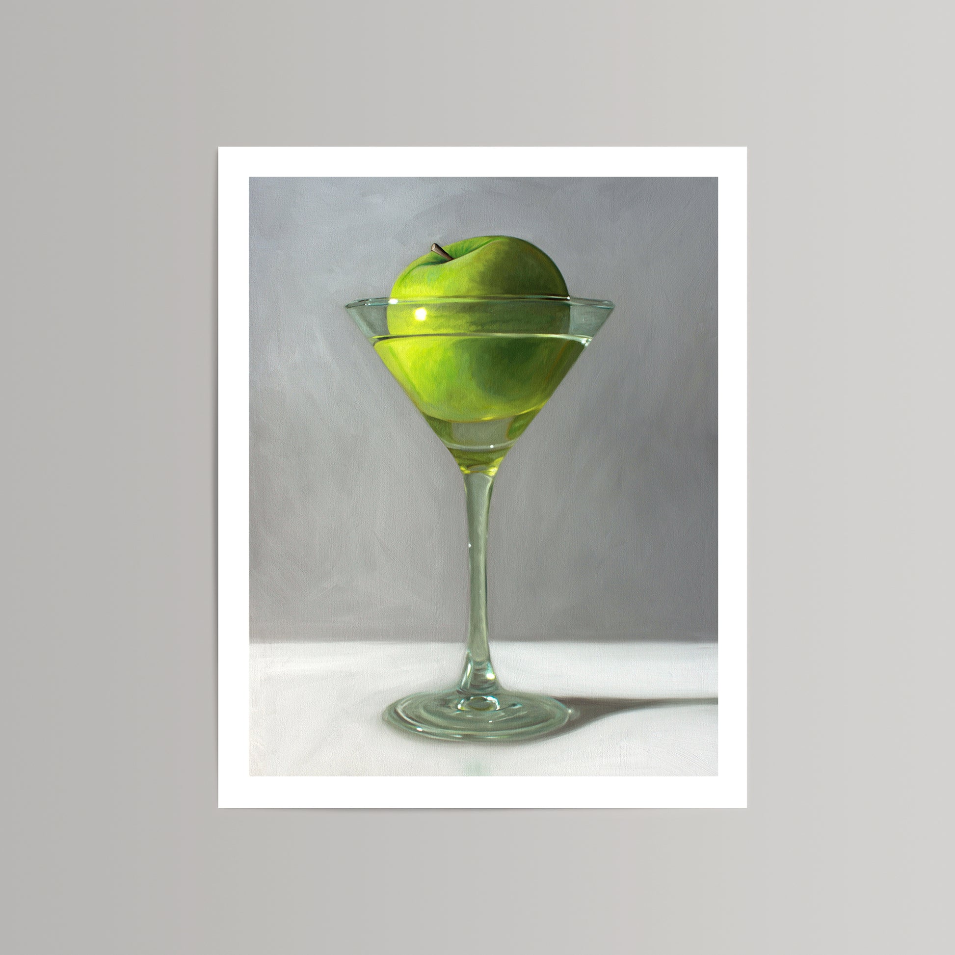 Vibrant green apple in a martini glass, fine art print with a white border.