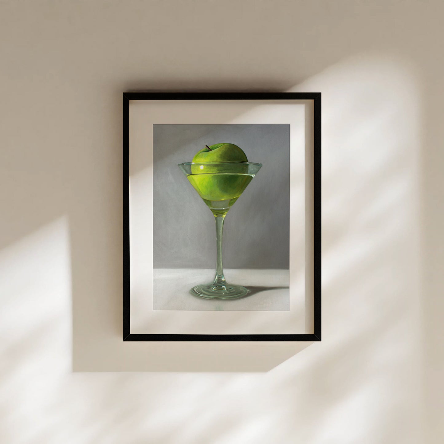 Framed fine art print of a vibrant green apple floating in a martini glass.