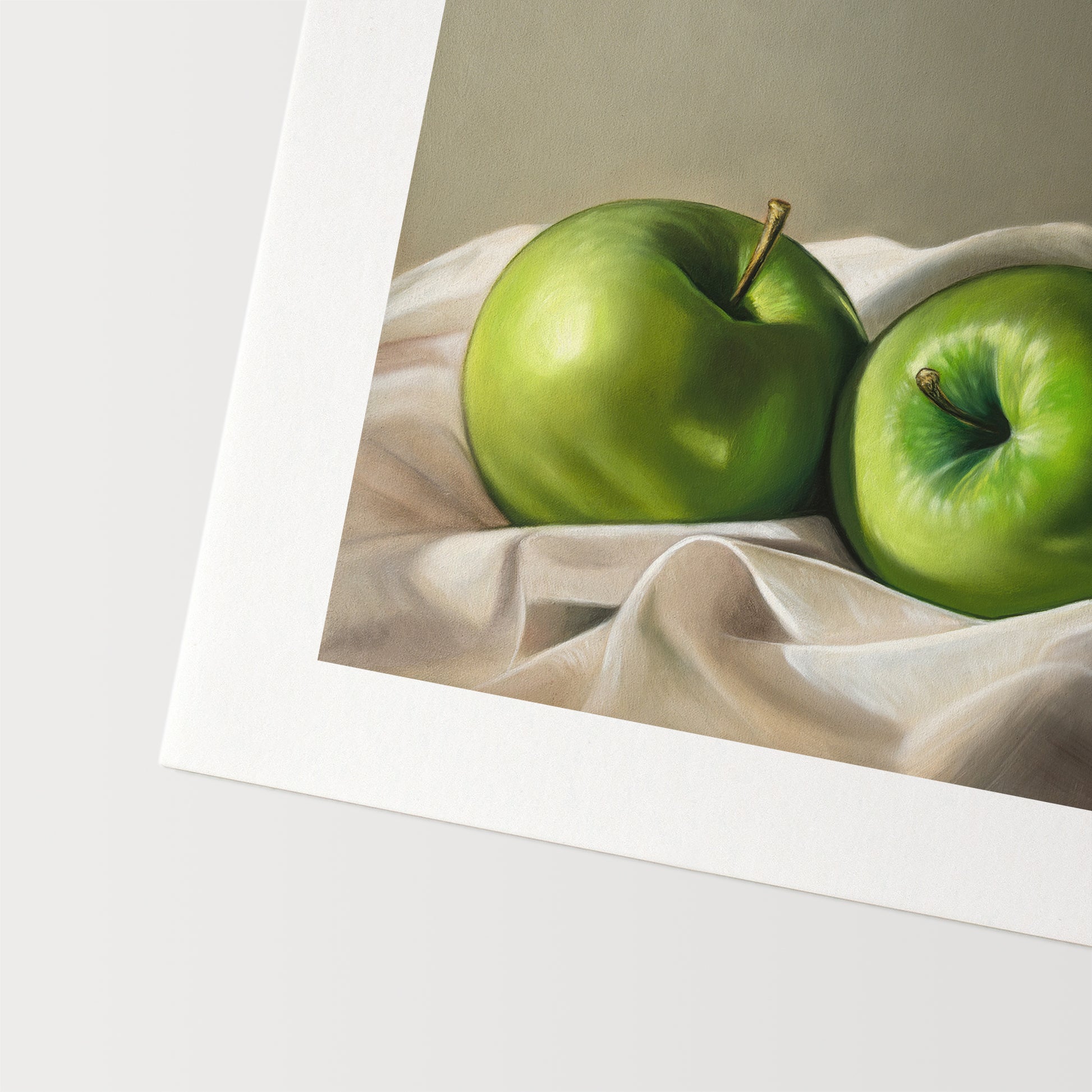Apples & Linen Fine Art Print by Lauren Pretorius: a pair of Granny Smith apples wrapped in linen fabric with a neutral grey background.