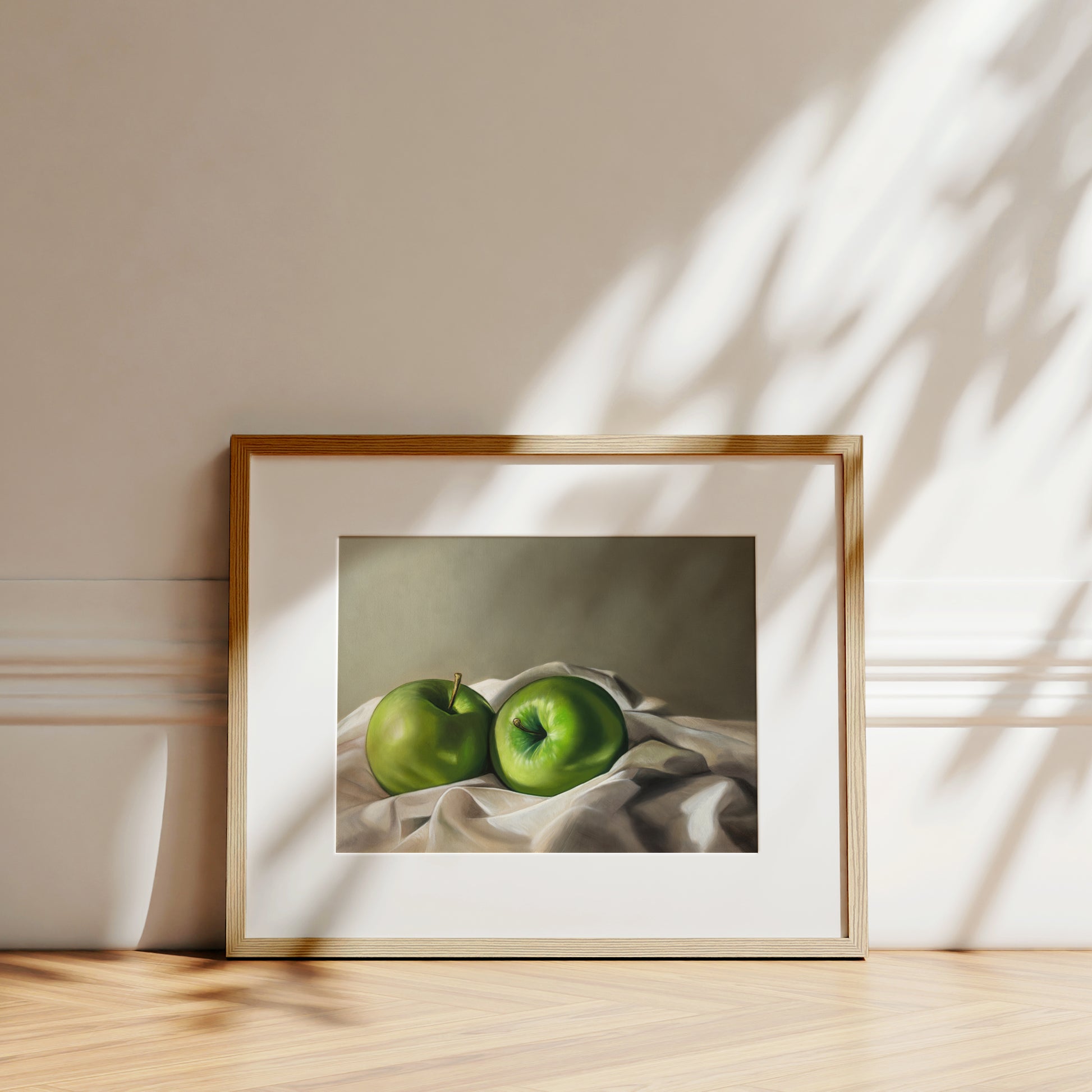 Apples & Linen Fine Art Print by Lauren Pretorius: a pair of Granny Smith apples wrapped in linen fabric with a neutral grey background.