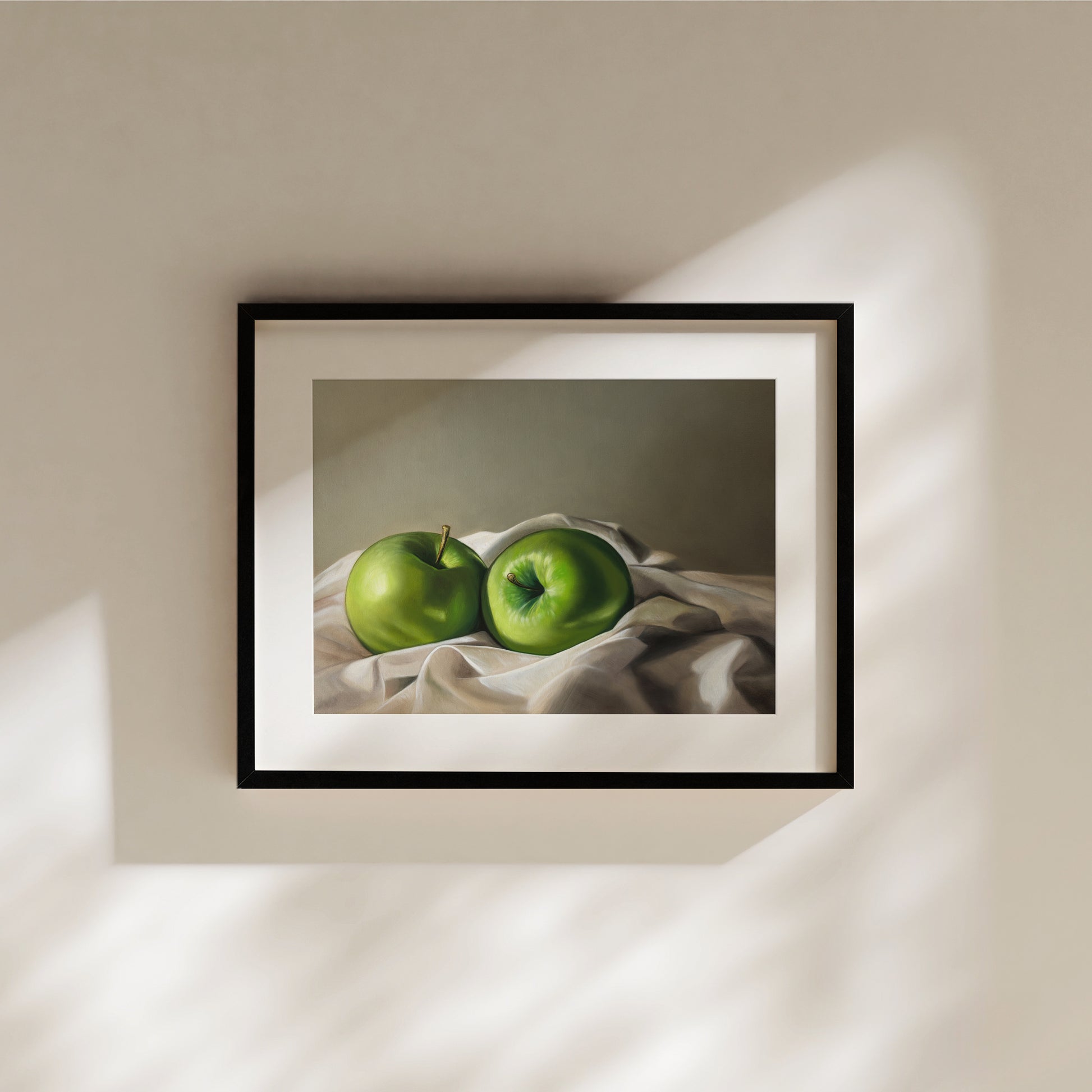Apples & Linen Fine Art Print by Lauren Pretorius: a pair of Granny Smith apples wrapped in linen fabric with a neutral grey background.