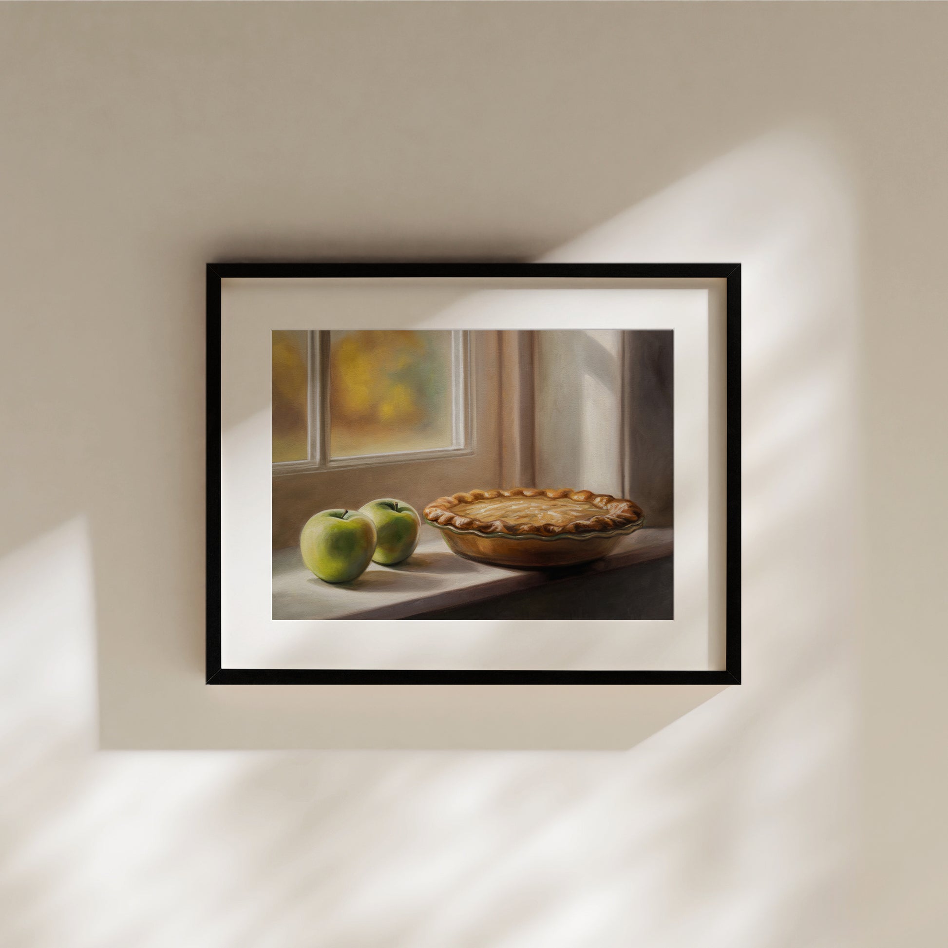Framed fine art print of an autumn apple pie and two green apples on a sunlit windowsill.