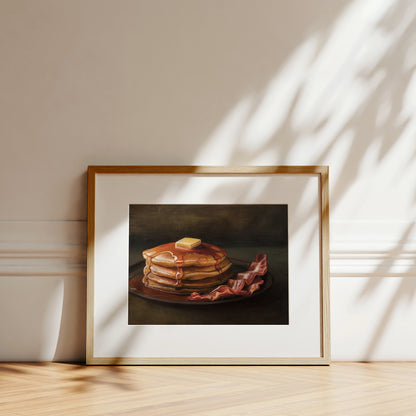 Bacon & Pancakes Fine Art Print by Lauren Pretorius: a stack of pancakes with butter and syrup resting on a plate, there are a couple of slices of bacon off to the right.