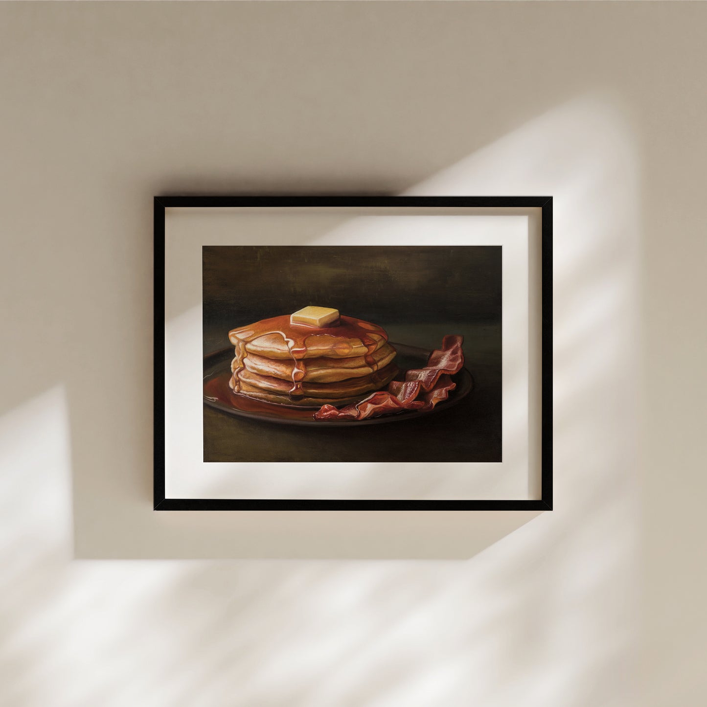 Bacon & Pancakes Fine Art Print by Lauren Pretorius: a stack of pancakes with butter and syrup resting on a plate, there are a couple of slices of bacon off to the right.