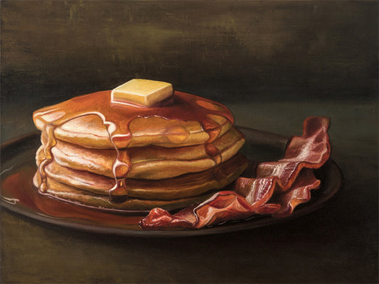 Bacon & Pancakes Fine Art Print by Lauren Pretorius: a stack of pancakes with butter and syrup resting on a plate, there are a couple of slices of bacon off to the right.