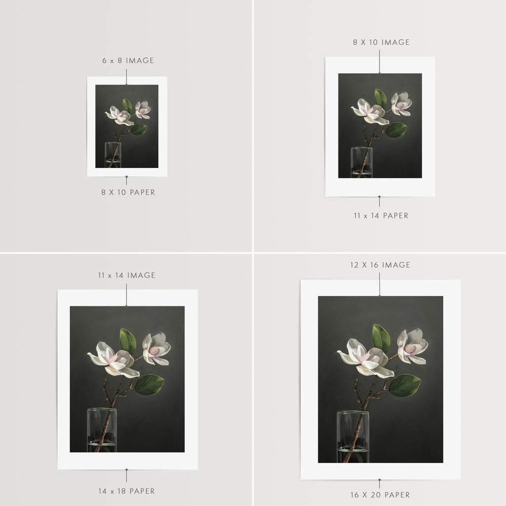 This artwork features a duo of magnolia blooms in a slim glass vase set against a dark backdrop.