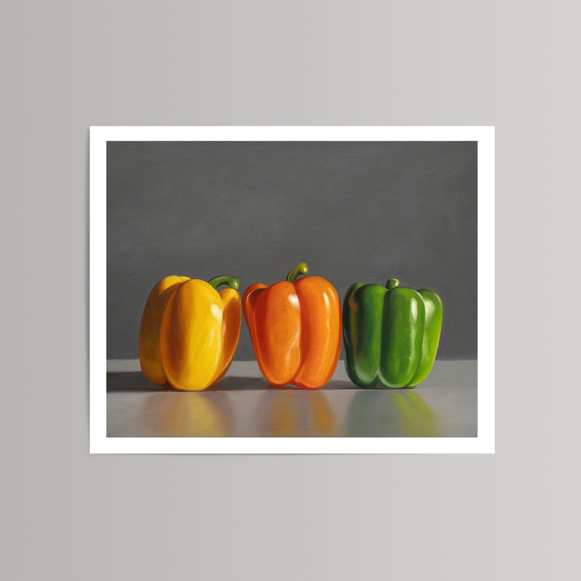 Fine art print of three vibrant bell peppers: yellow, orange, and green, on a gray background.