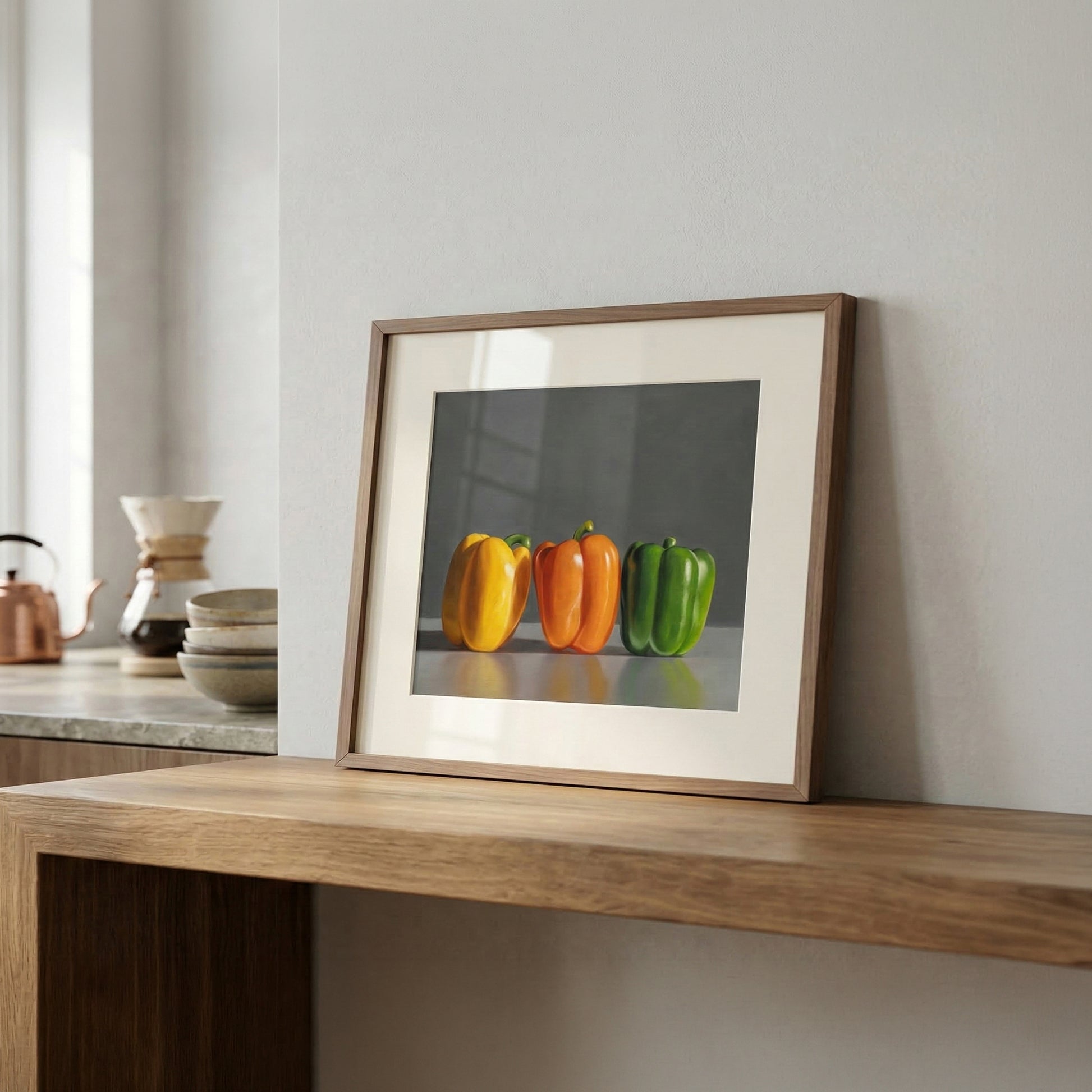 Fine art print of three vibrant bell peppers (yellow, orange, green) in a natural wood frame.