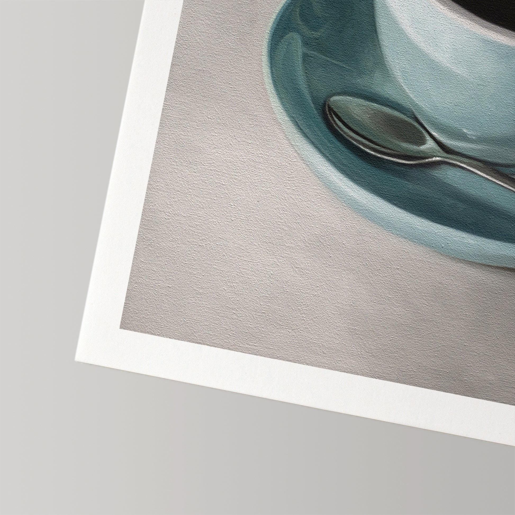 Fine art print of a blue coffee cup with a spoon on a gray background, featuring a white border.