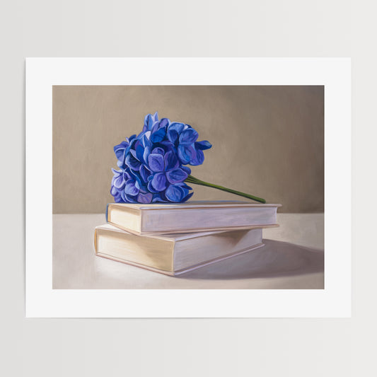 Blue Hydrangeas & Books Fine Art Print by Lauren Pretorius: blue hydrangeas arranged on top of a stack of books.