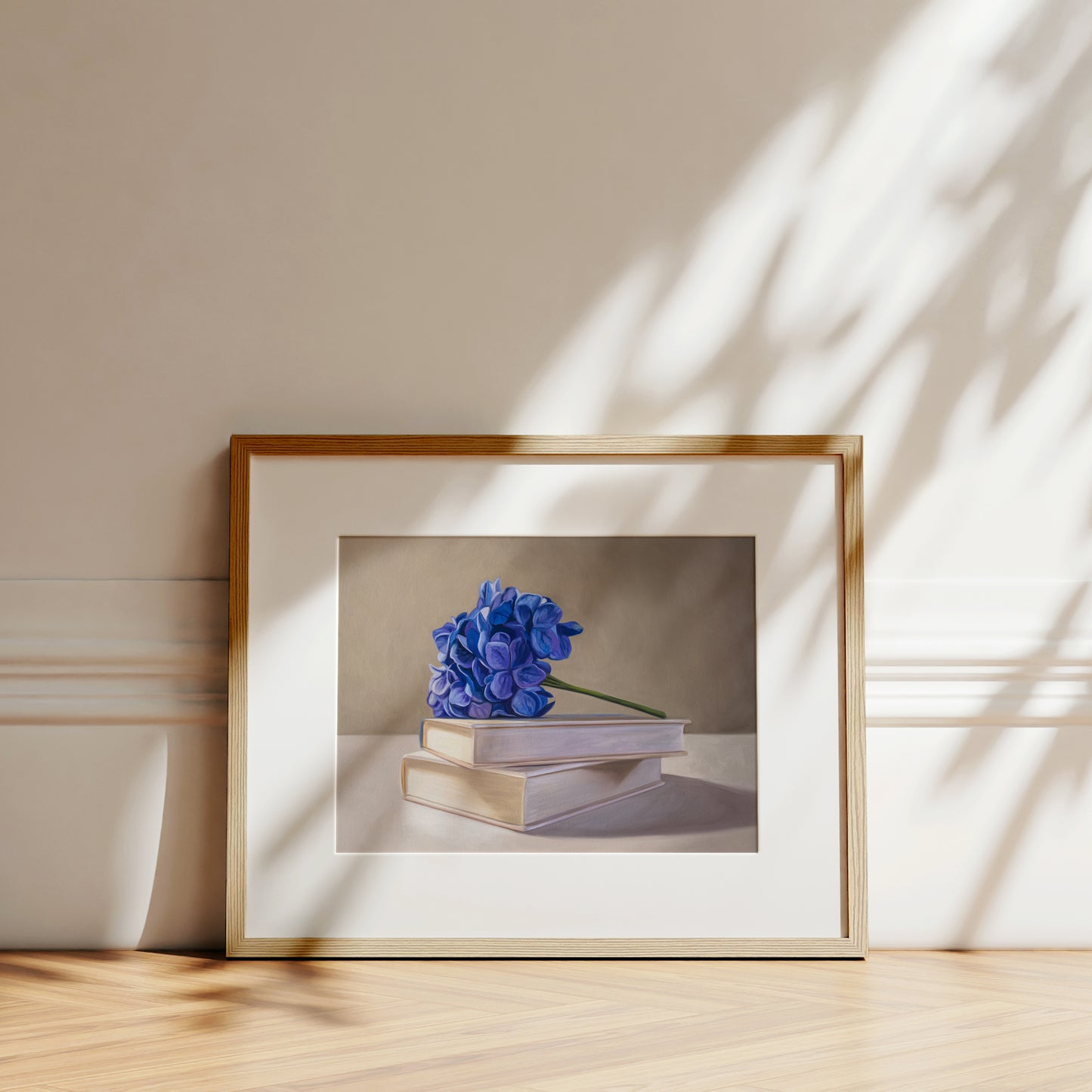 Blue Hydrangeas & Books Fine Art Print by Lauren Pretorius: blue hydrangeas arranged on top of a stack of books.