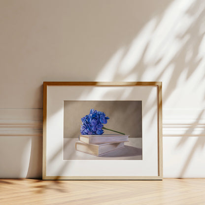 Blue Hydrangeas & Books Fine Art Print by Lauren Pretorius: blue hydrangeas arranged on top of a stack of books.