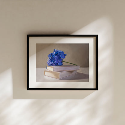 Blue Hydrangeas & Books Fine Art Print by Lauren Pretorius: blue hydrangeas arranged on top of a stack of books.