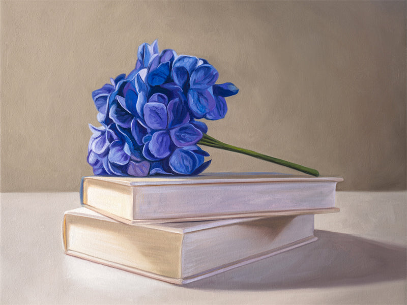 Blue Hydrangeas & Books Fine Art Print by Lauren Pretorius: blue hydrangeas arranged on top of a stack of books.