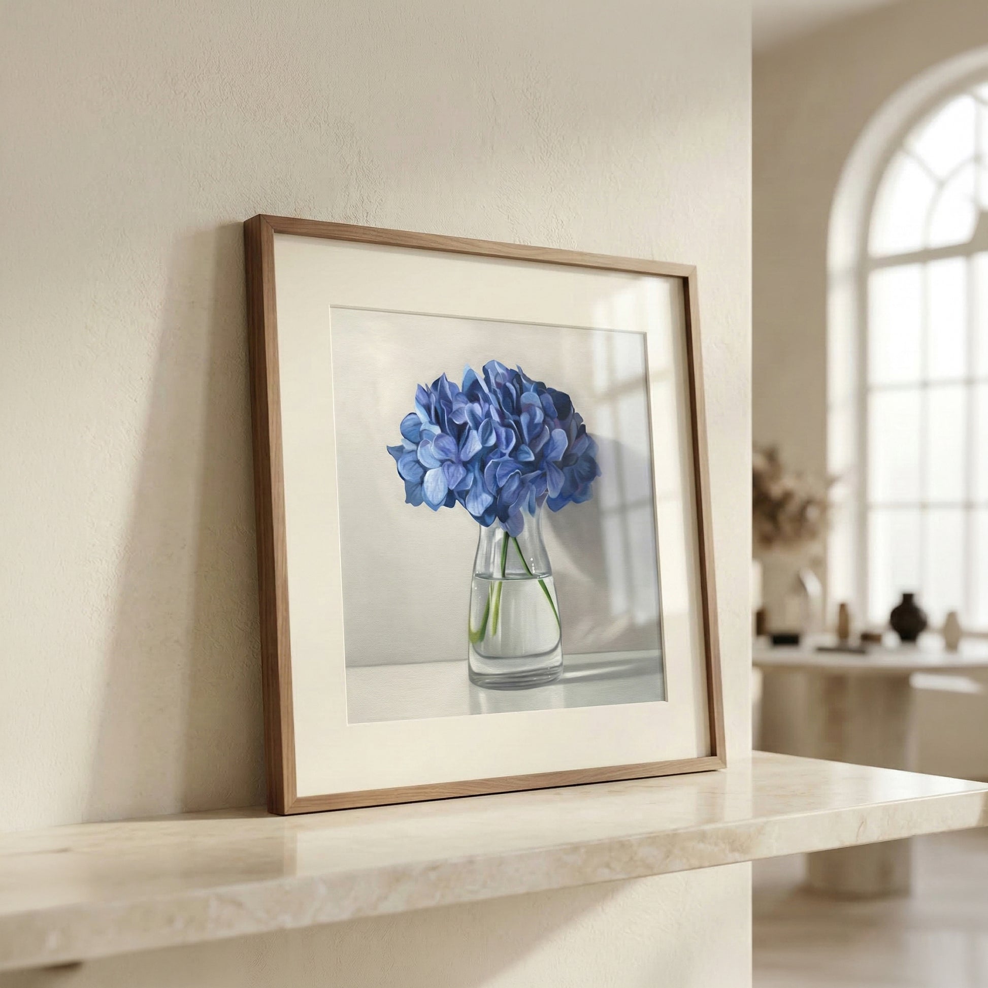 Framed fine art print of vibrant blue hydrangeas in a clear vase, displayed on a marble surface.