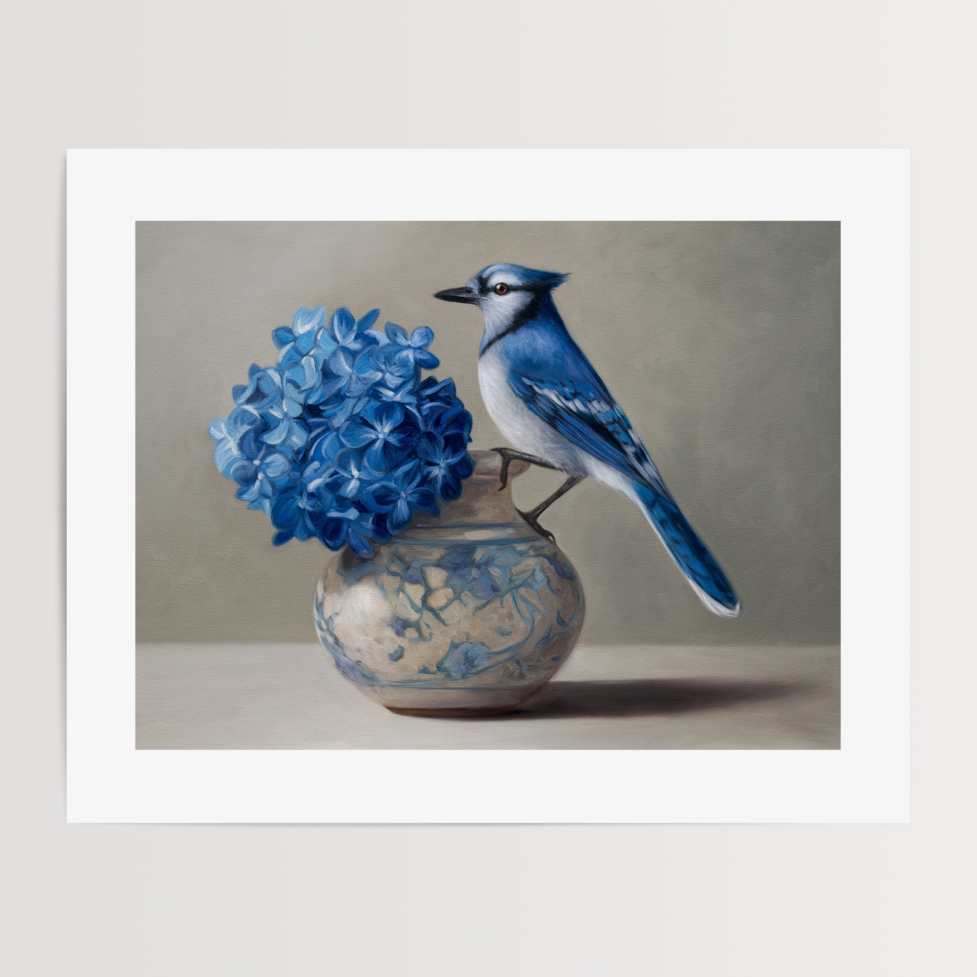 Blue Jay & Hydrangeas Fine Art Print by Lauren Pretorius: a Blue jay perched on a vase with blue hydrangea flowers against a neutral background