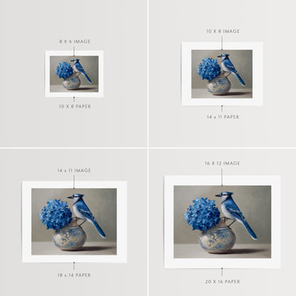 Blue Jay & Hydrangeas Fine Art Print by Lauren Pretorius: a Blue jay perched on a vase with blue hydrangea flowers against a neutral background