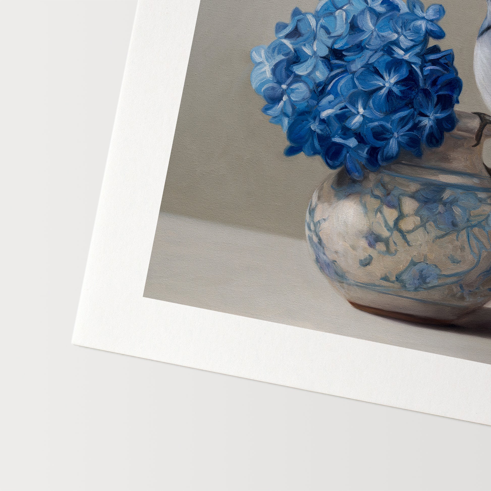 Blue Jay & Hydrangeas Fine Art Print by Lauren Pretorius: a Blue jay perched on a vase with blue hydrangea flowers against a neutral background